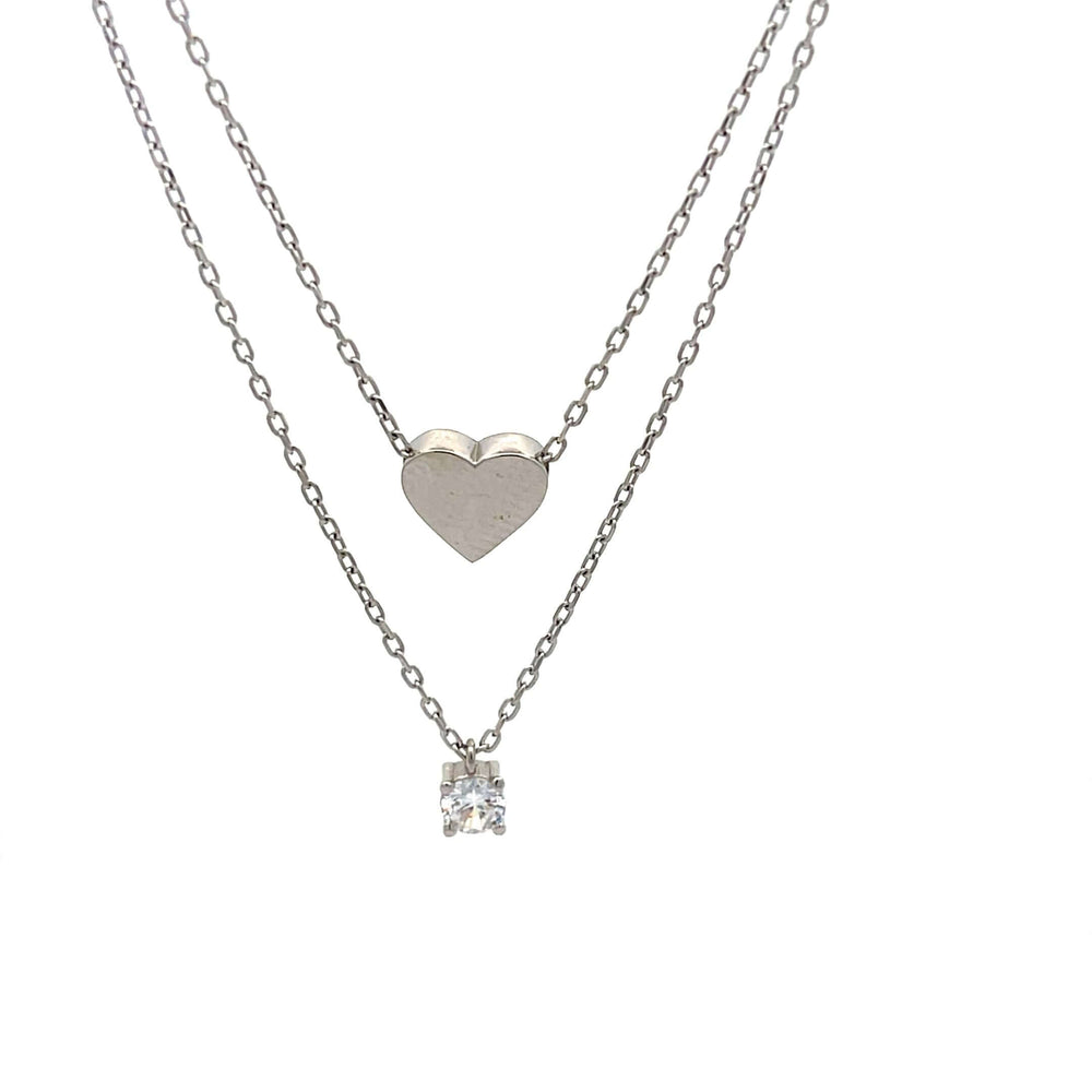 Детайлен изглед на двойно дамско колие с висулки сърце и кристал.