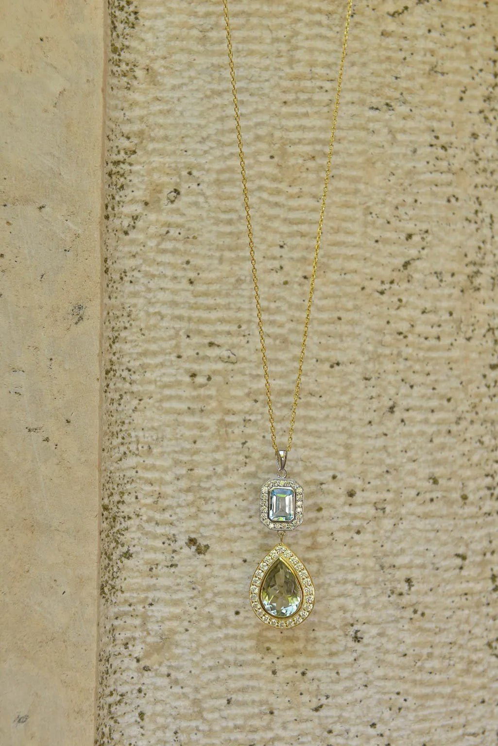 Сребърно колие Salvatore Plata с аметист и топаз, поставено на текстурирана повърхност.