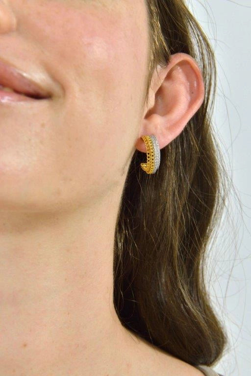 Two-tone silver hoop earrings with CZ Salvatore Plata — worn on a model