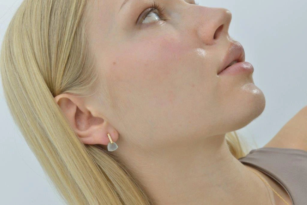 Gold-plated silver earrings with pale blue drops Salvatore Plata — worn on a model