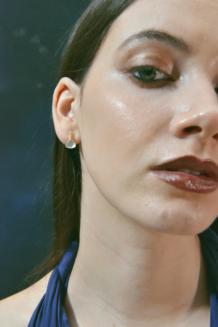 Gold-plated silver earrings with pale blue drops Salvatore Plata — worn on a model