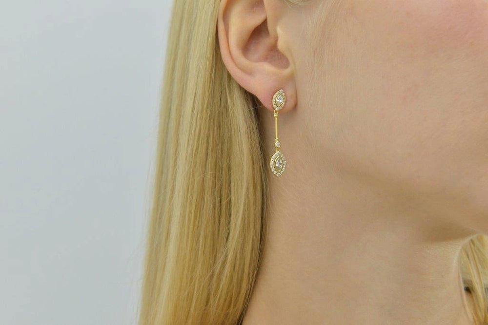Gold-plated silver drop earrings with white CZ Salvatore Plata — worn on a model
