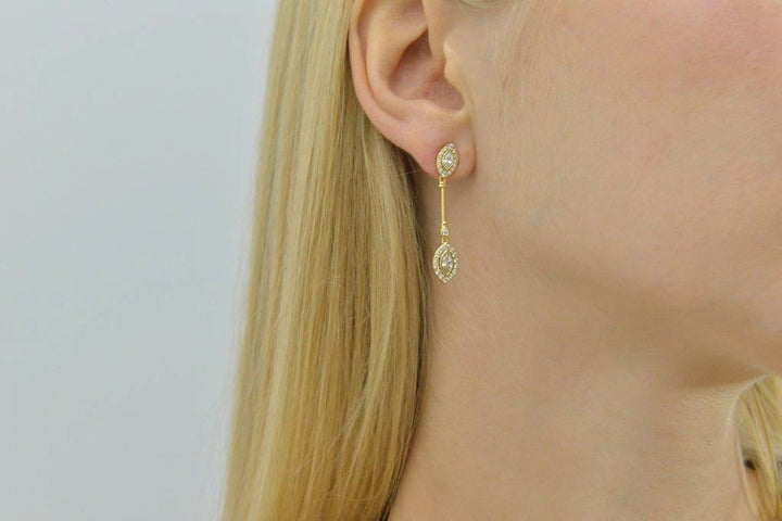 Gold-plated silver drop earrings with white CZ Salvatore Plata — worn on a model