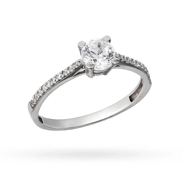 Бял златен пръстен с централен циркон и камъни по халката