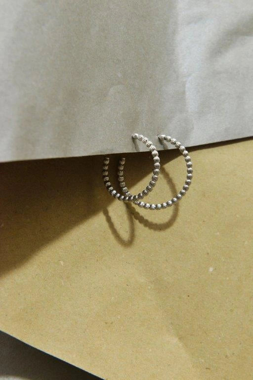 Silver hoop earrings with textured spheres Salvatore Plata — jewellery composition