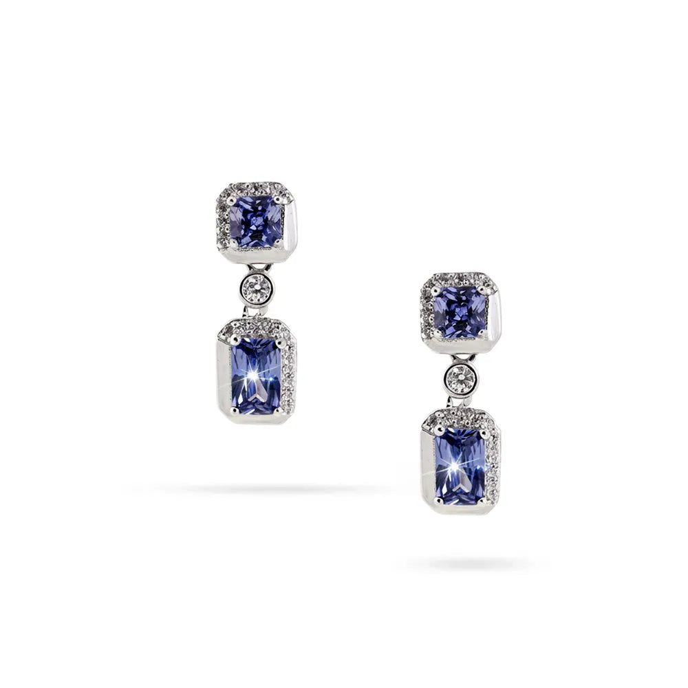 Сребърни висящи обеци с родиево покритие, сини и прозрачни циркони, изглед отпред на бял фон